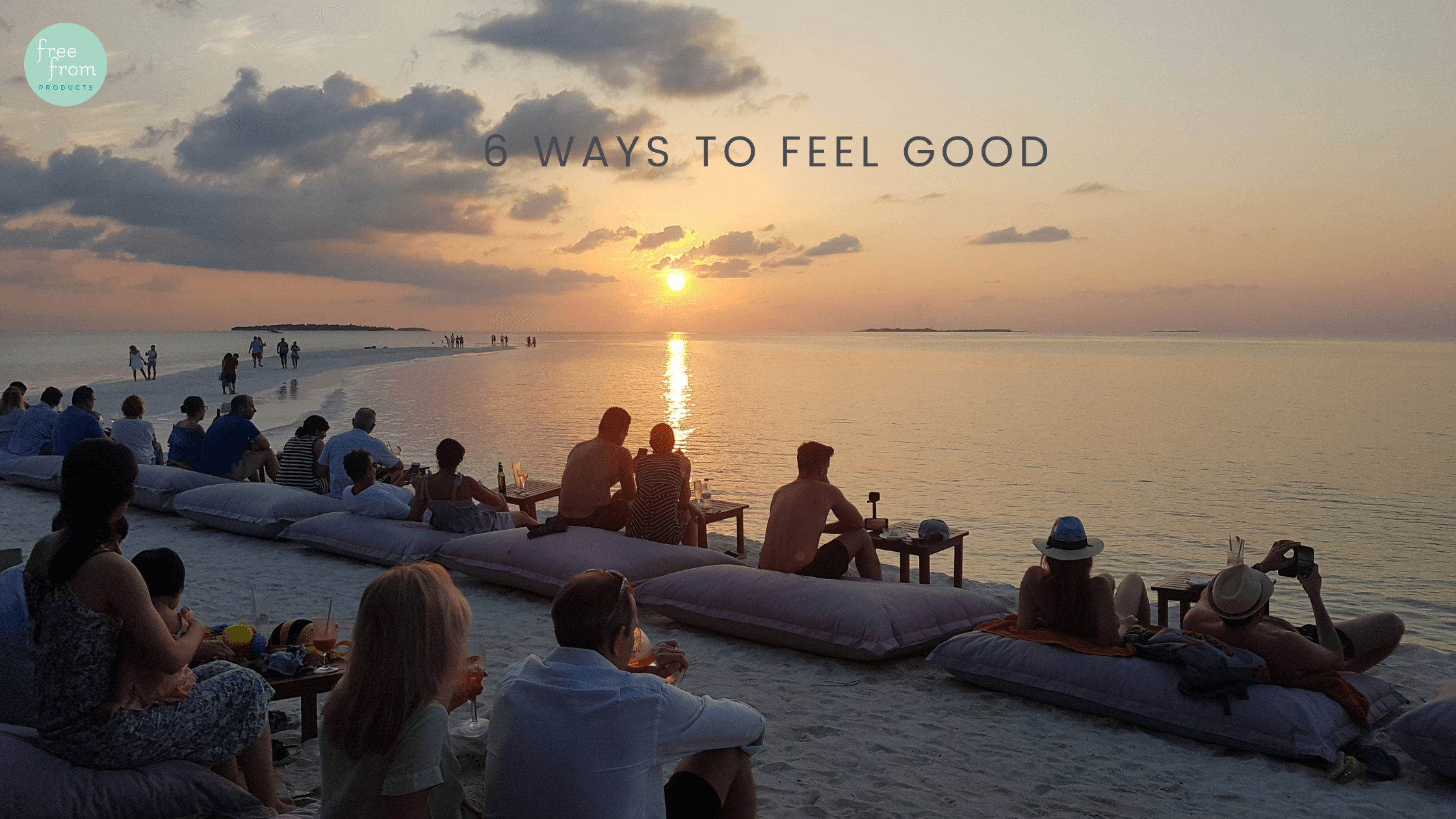 picture of a sunset beach with people on it